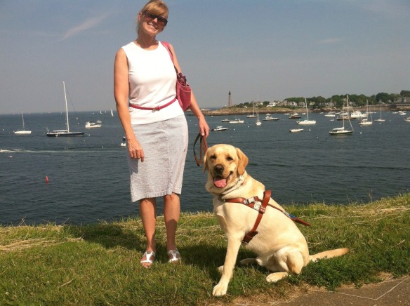 Jen and Keating posing on the grass in front of the ocean at Fort Sewall in Marblehead