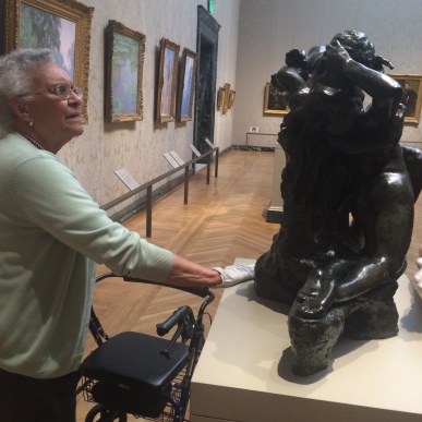 A low vision support group member touches a sculpture at the MFA Feeling for Form program